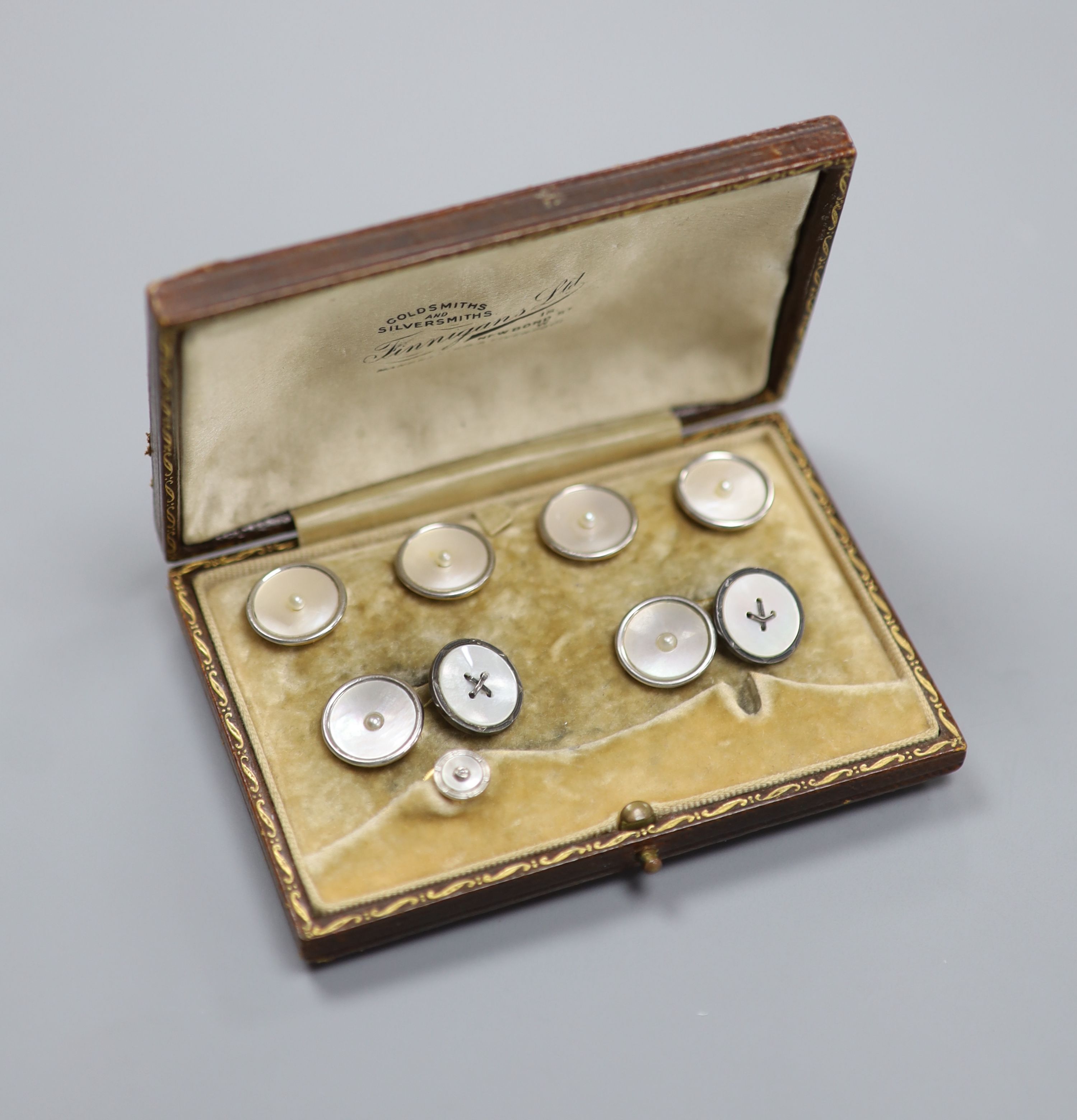 A yellow metal (stamped 18), mother of pearl and seed pearl set six piece part dress stud set and one other 18ct , mother of pearl and diamond set dress stud